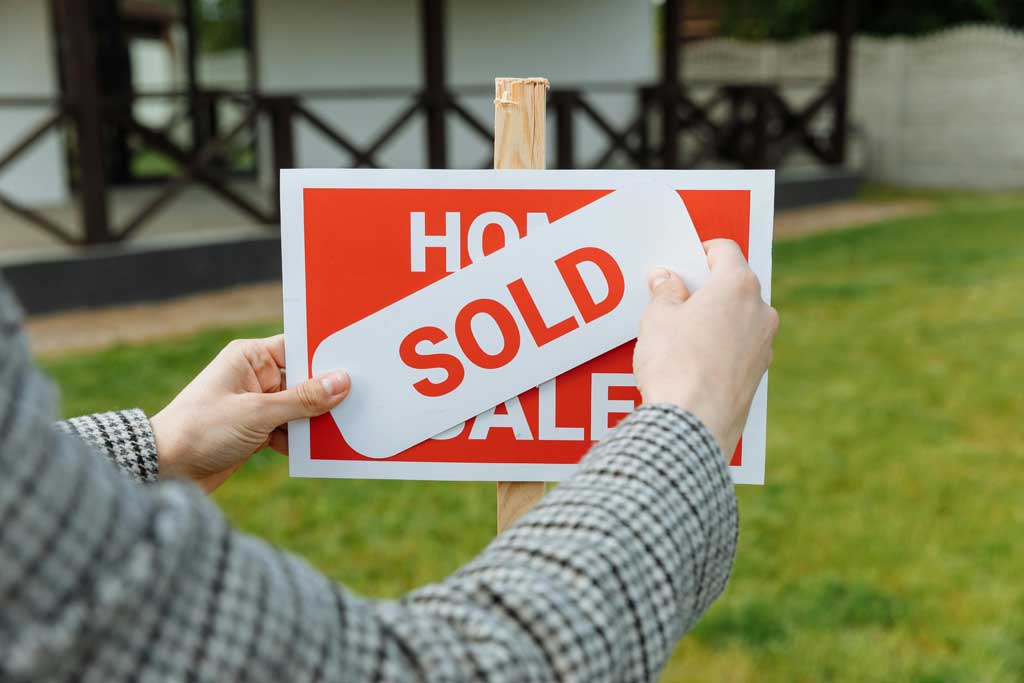 Realtor Posting a Sold Sticker
