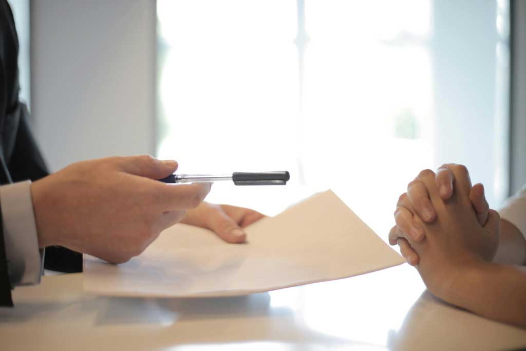 Giving-contract-to-woman-to-sign