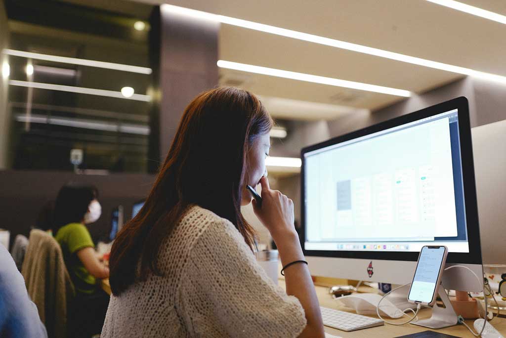 A woman sitting in front of a computer