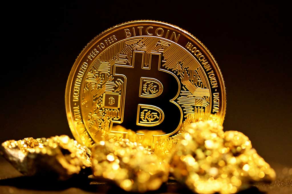A single bitcoin surrounded by raw gold pieces