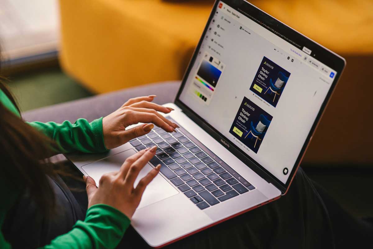Woman sitting on a couch using a laptop computer
