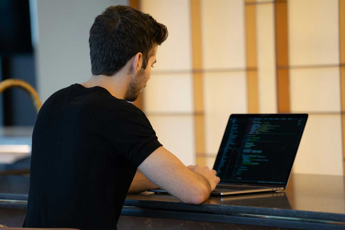 Man using laptop to coding