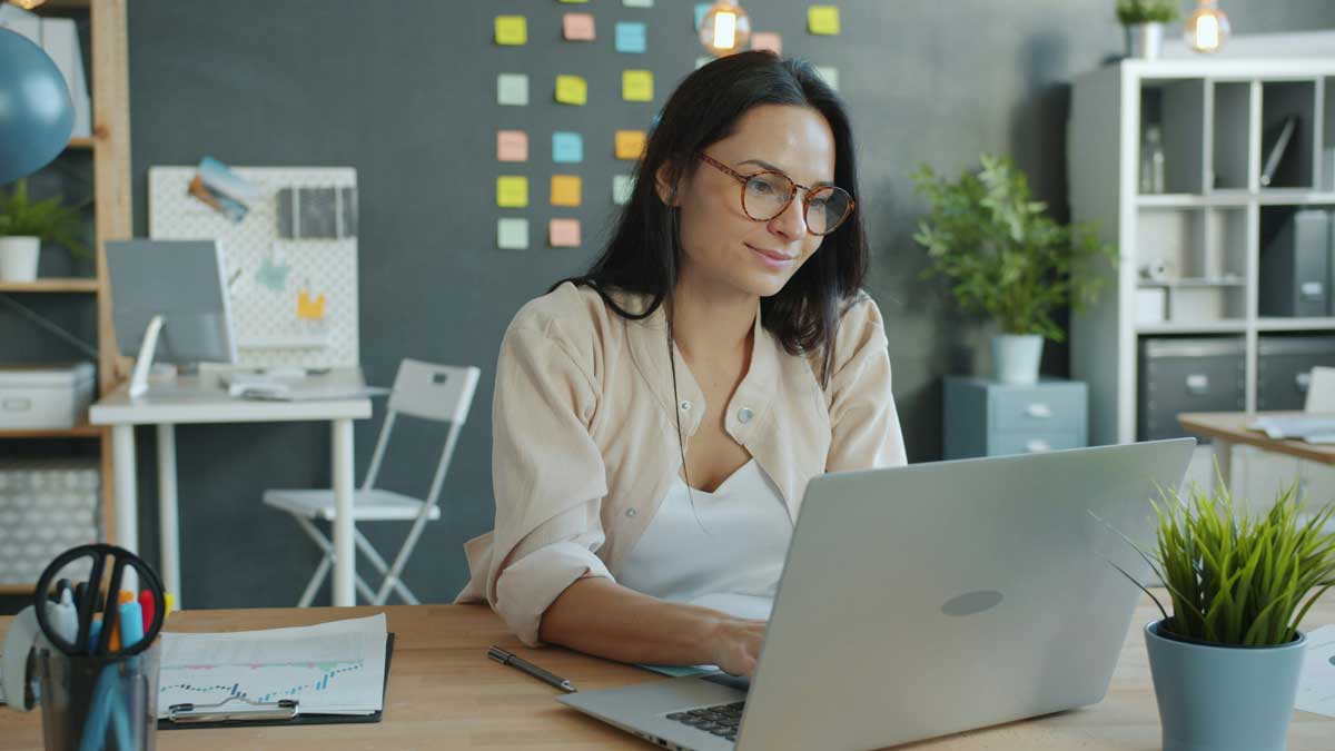 Woman working on a laptop in a modern office