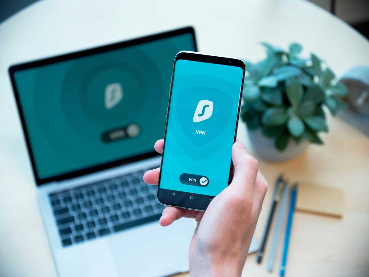 Person holding phone with VPN app displayed