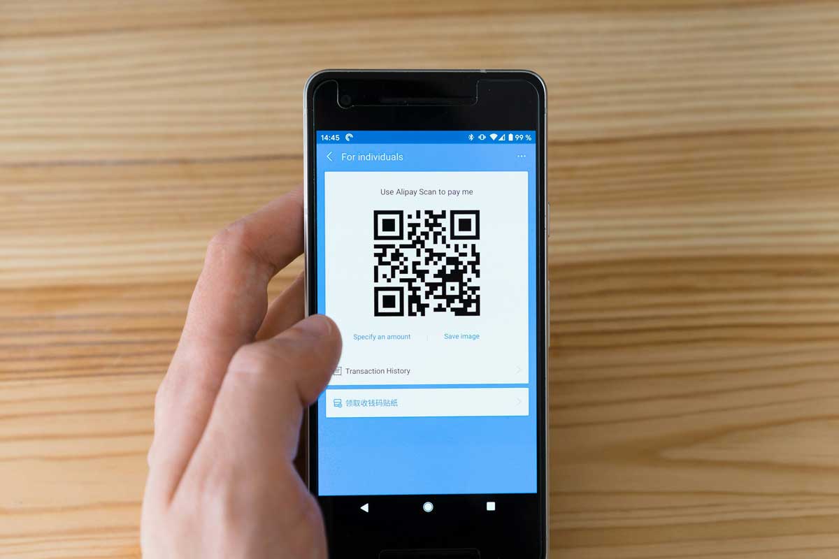 Black android smartphone displaying qr code