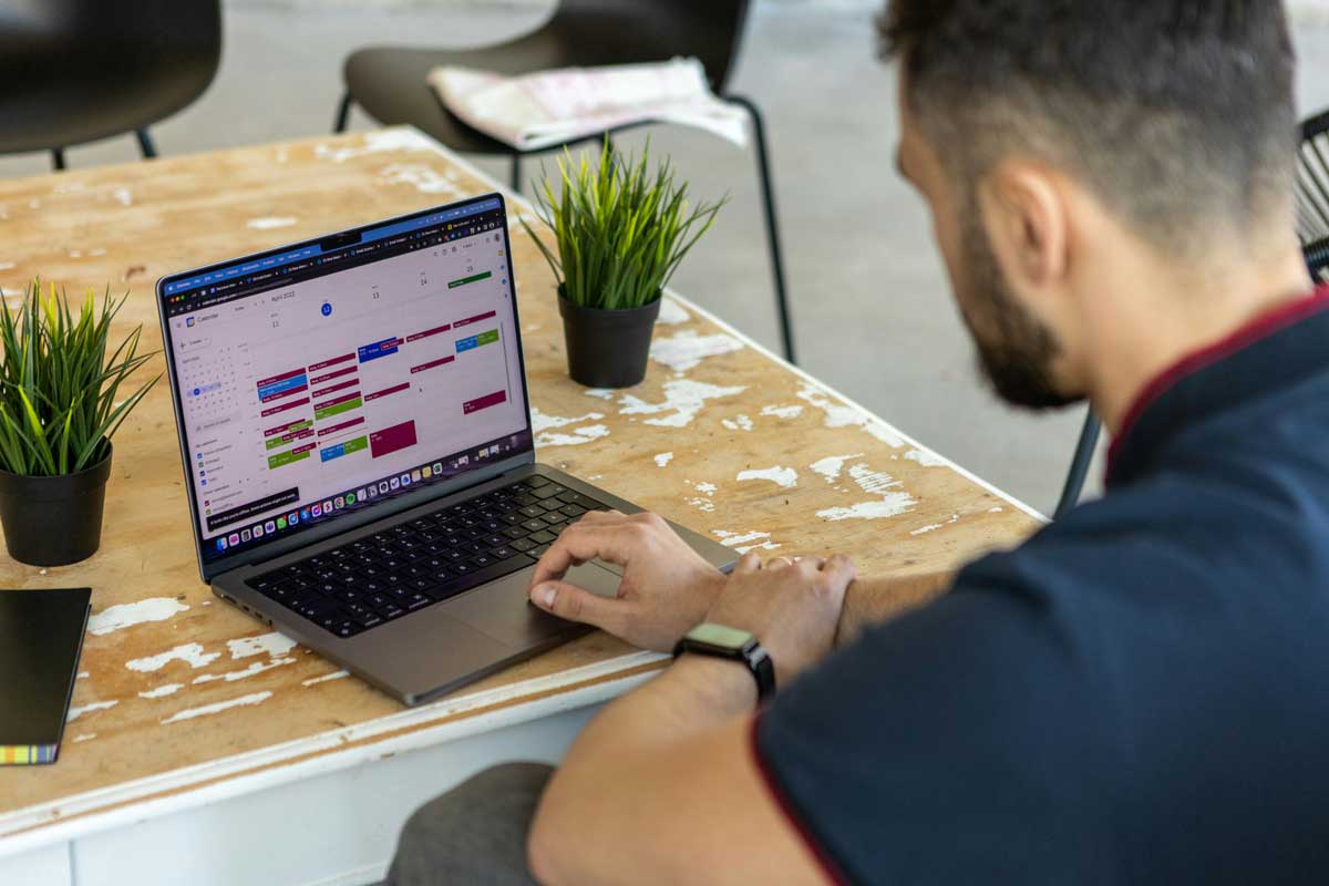 A person working on MacBook in a rusty old interior