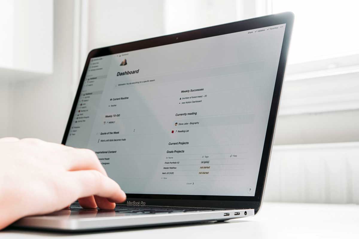 Person using black and silver laptop