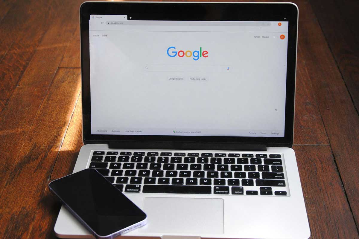 Laptop screen shows Google homepage