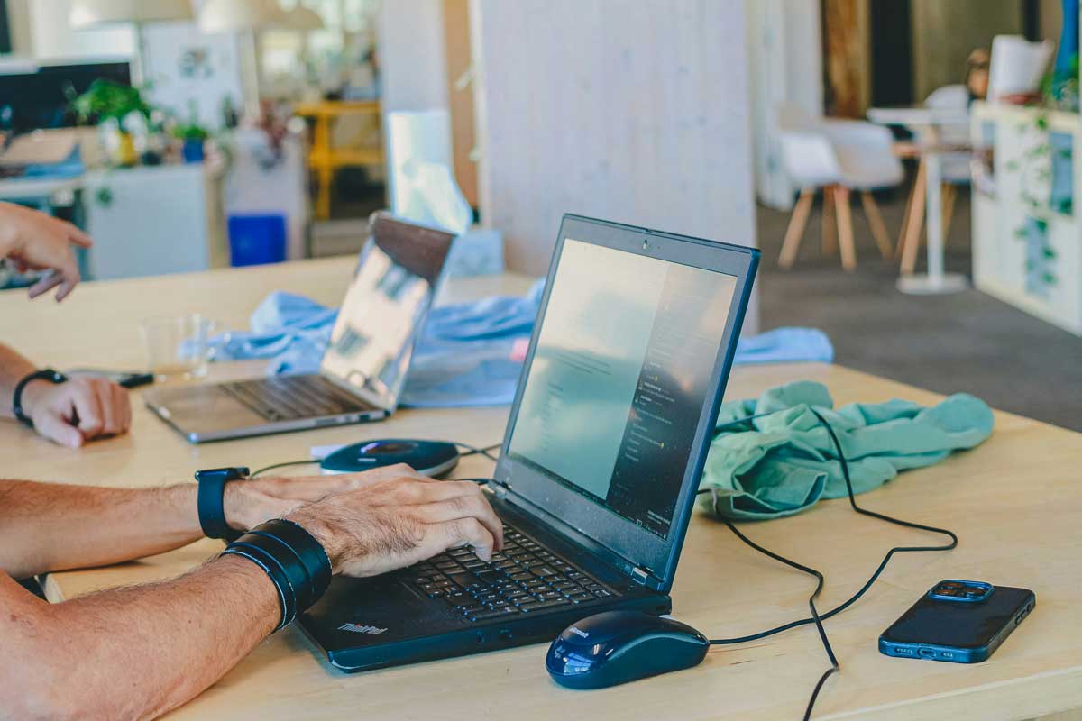 People working on laptops at a table