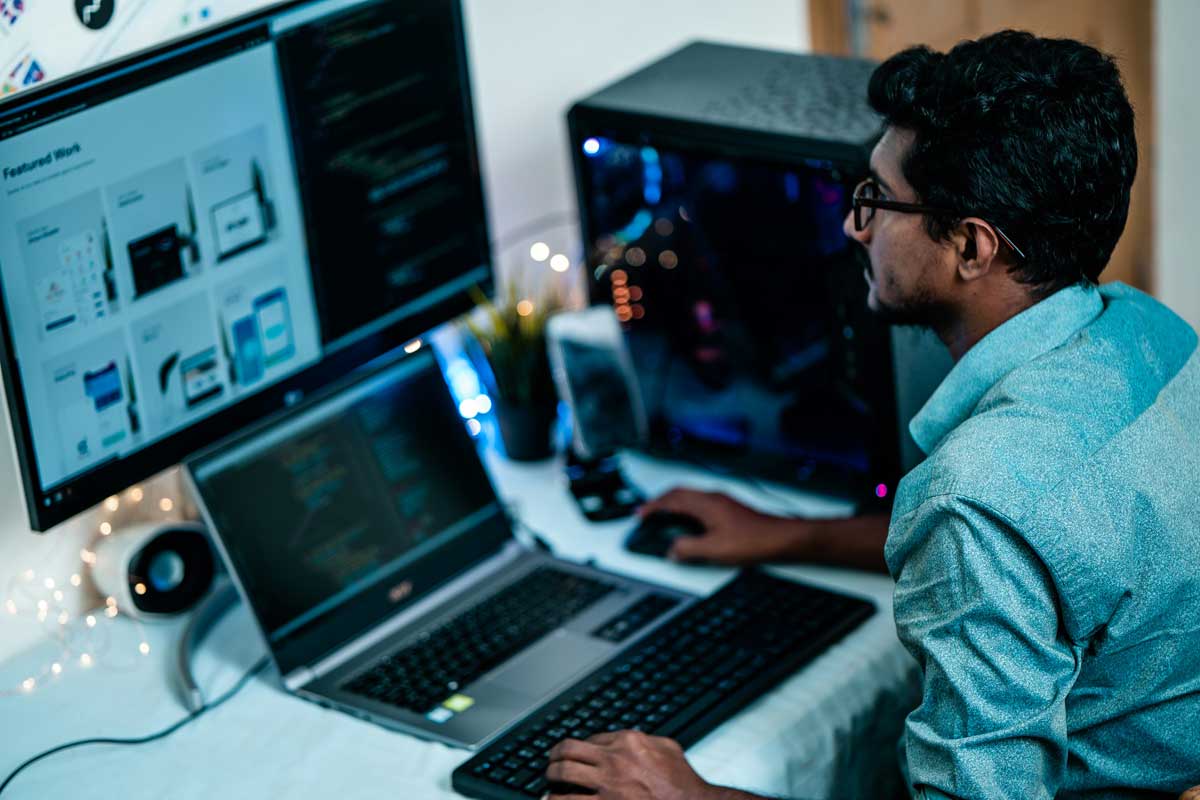 Man in blue dress shirt using computer