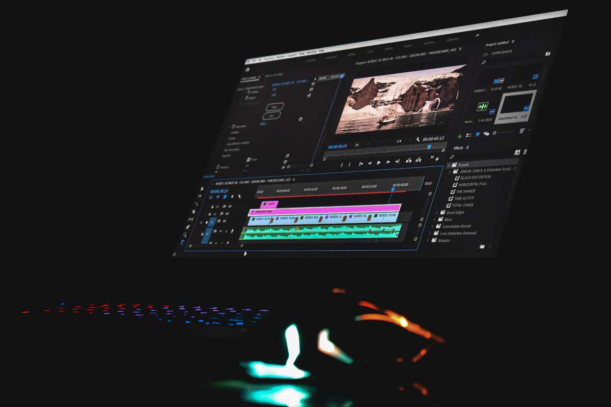 Black laptop computer turned on displaying video player