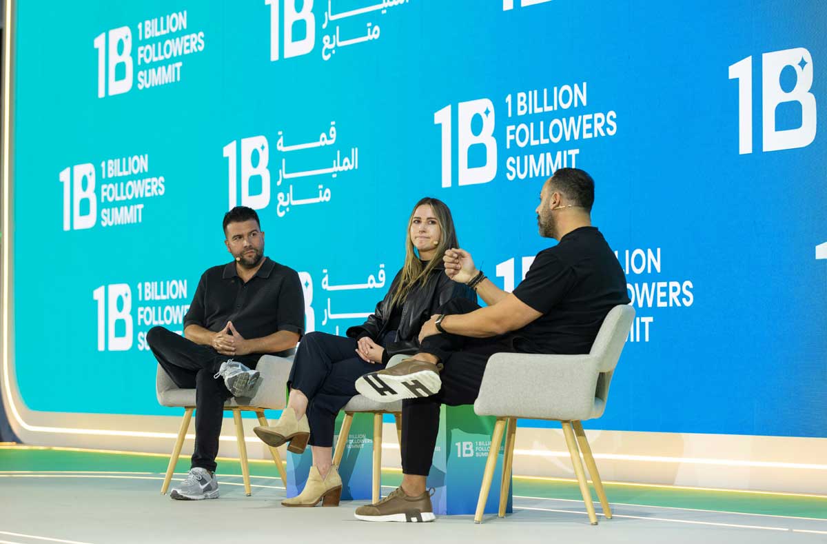 Carlos Gil presenting on stage at a large-scale international conference, sharing insights on personal branding, audience ownership, and monetization strategies for creators and entrepreneurs.
