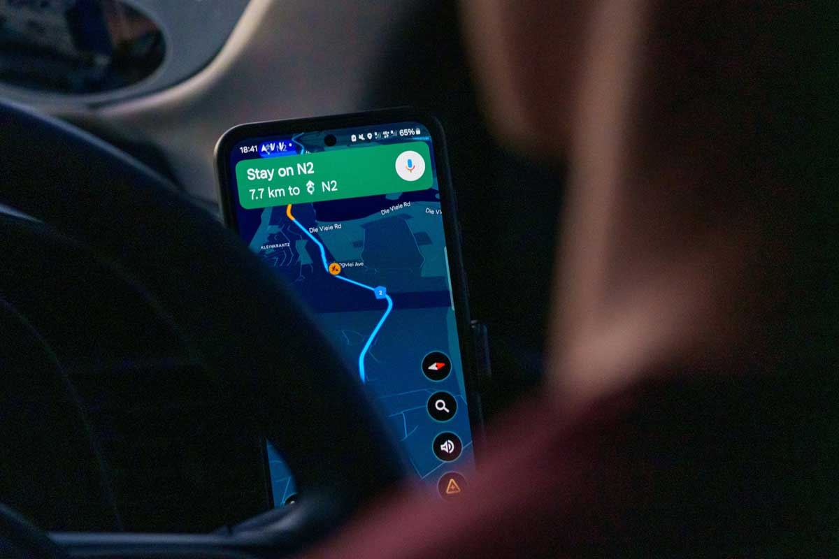 A man drives while using Google maps.