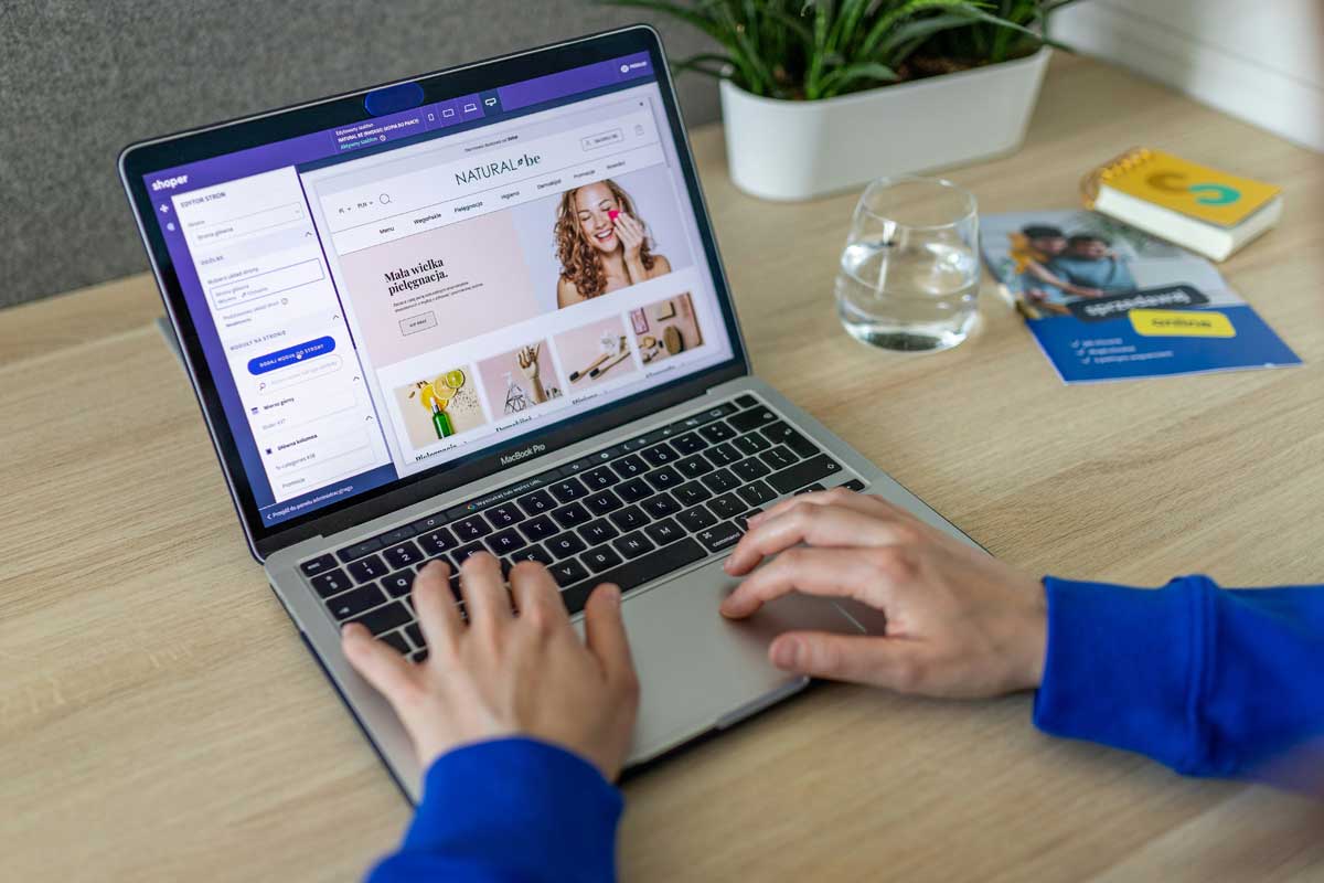 Hands typing on keyboard, changing online store design