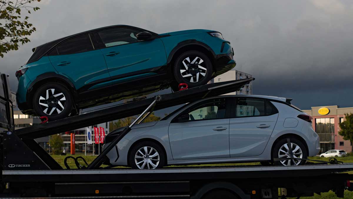 Two cars loaded onto a car carrier truck