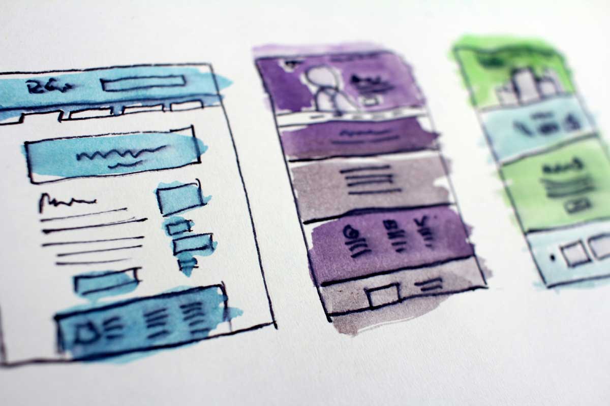 Watercolor wireframe sketches of website layouts