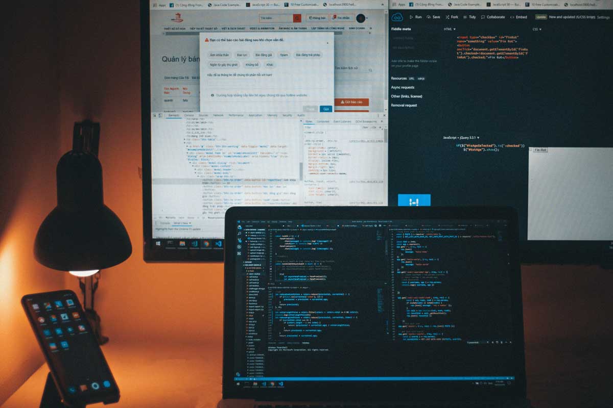 A computer monitor and a laptop on a desk