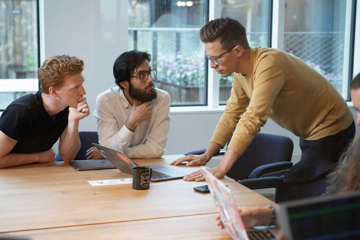 A group of people sitting around a wooden table