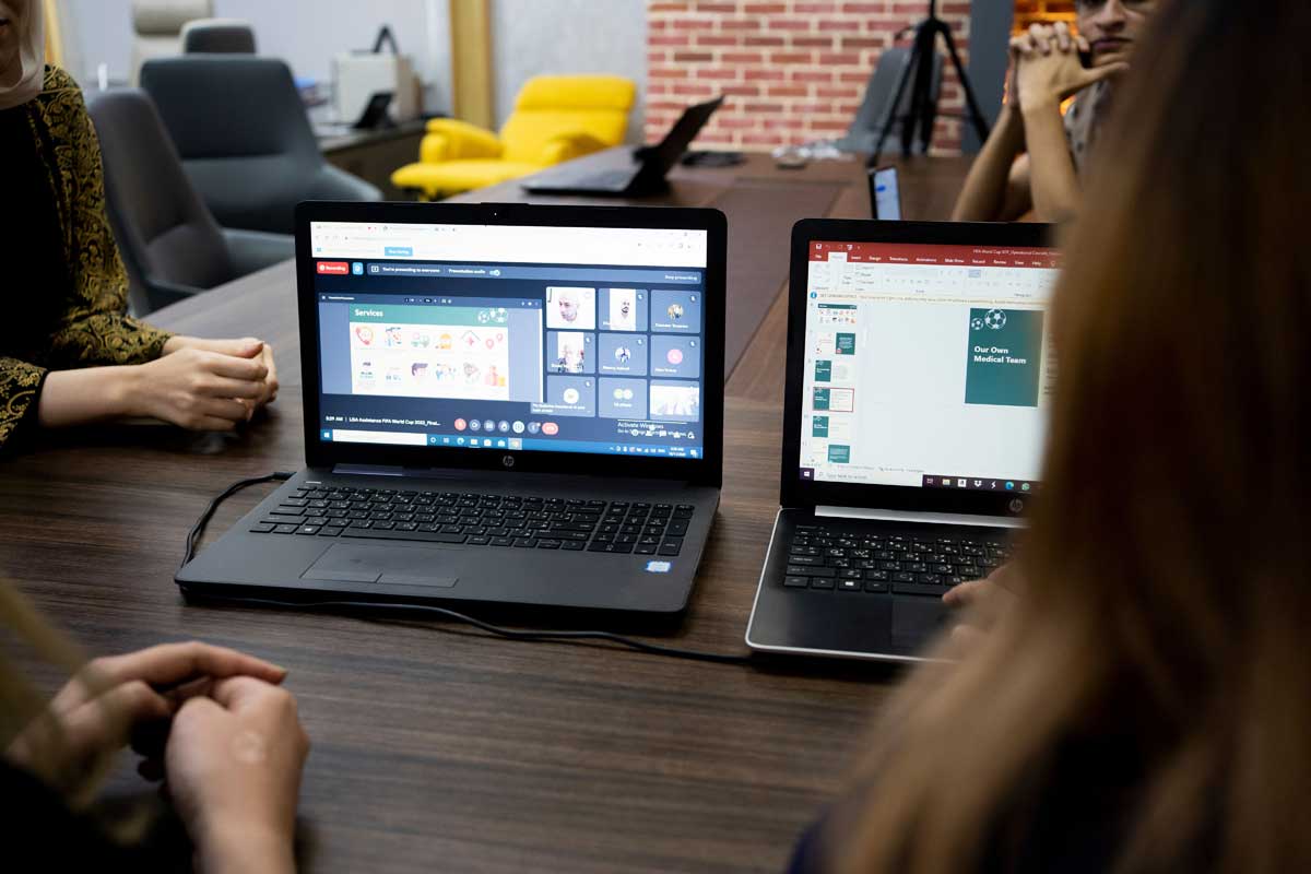 Team discusses projects during a virtual and in-person meeting