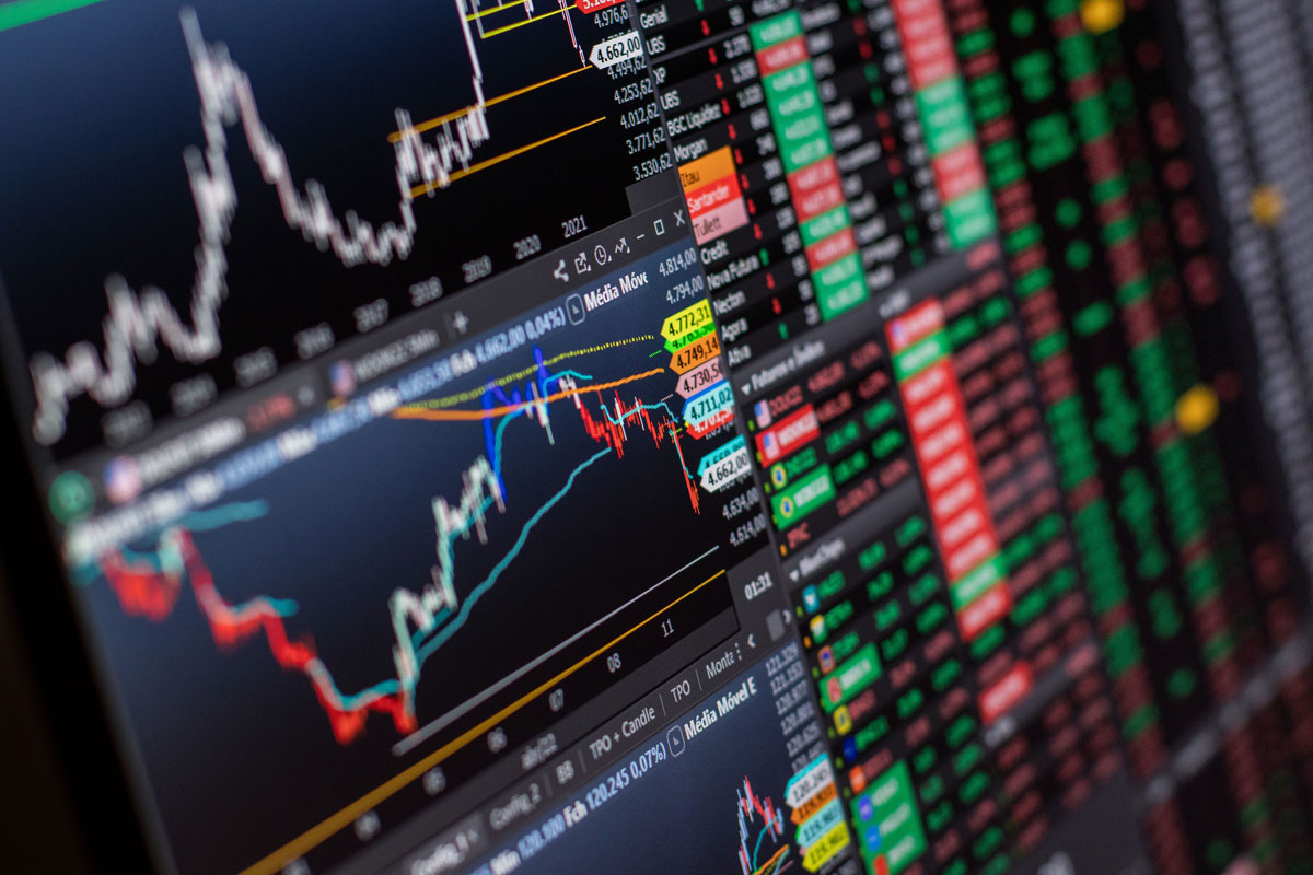 Detailed view of stock market charts and data on a monitor, showcasing market trends