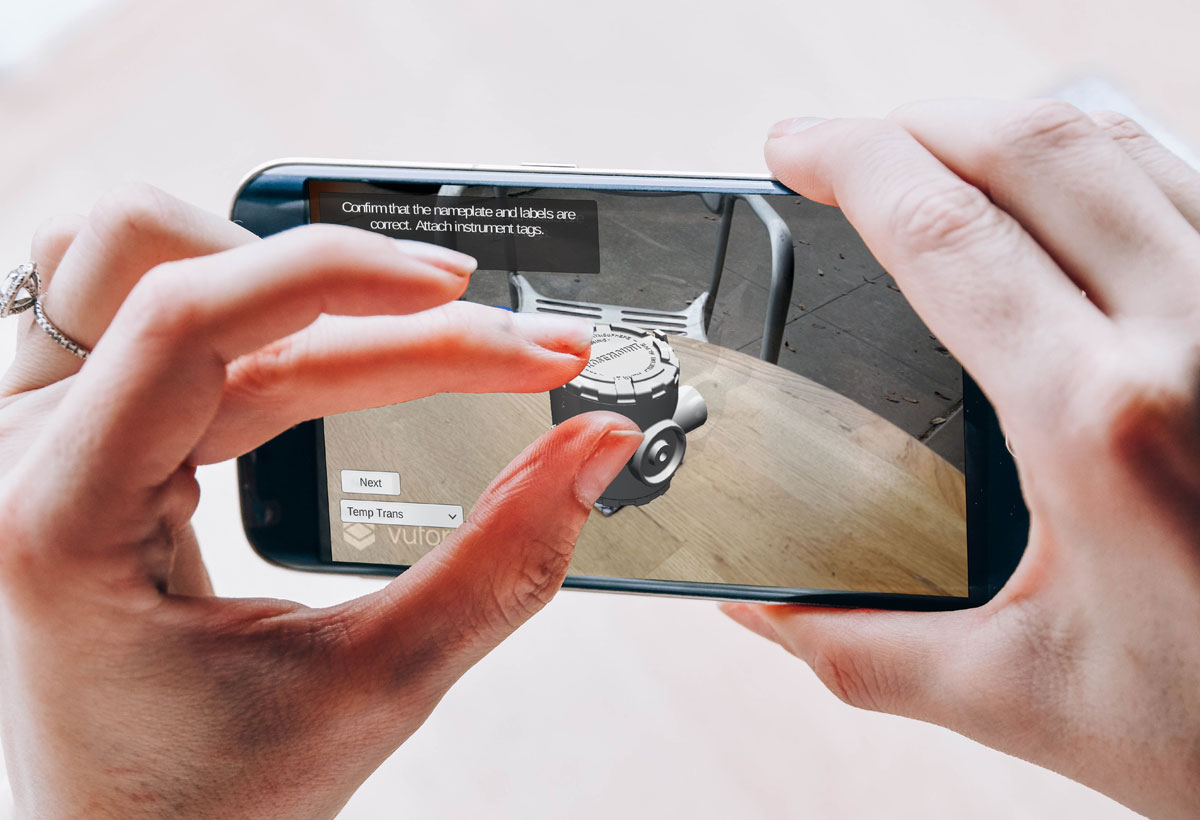 Hands holding a smartphone with augmented reality application indoors