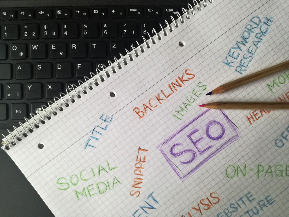 Close-up of notebook with SEO terms and keywords, highlighting digital marketing strategy