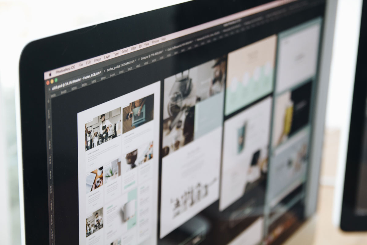 A modern computer screen displaying web design work, showcasing creative visuals in a workspace