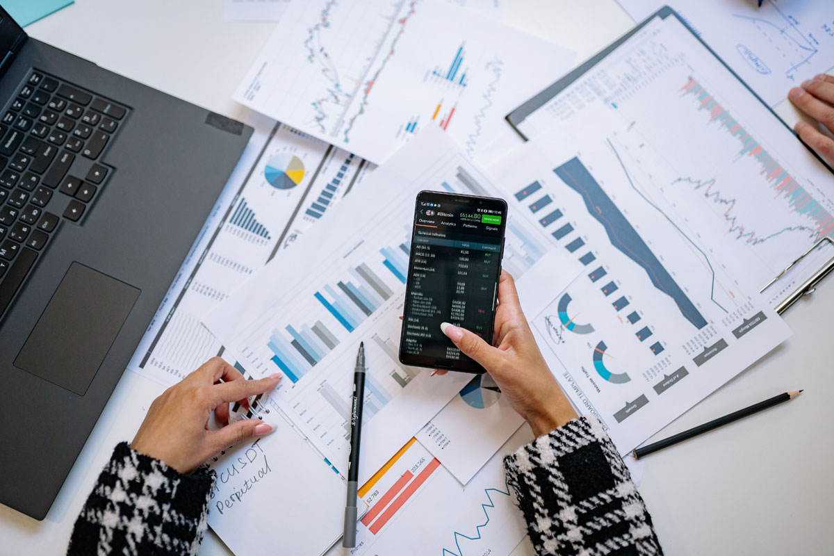 A top view on charts and smartphone in an office, showcasing data analytics