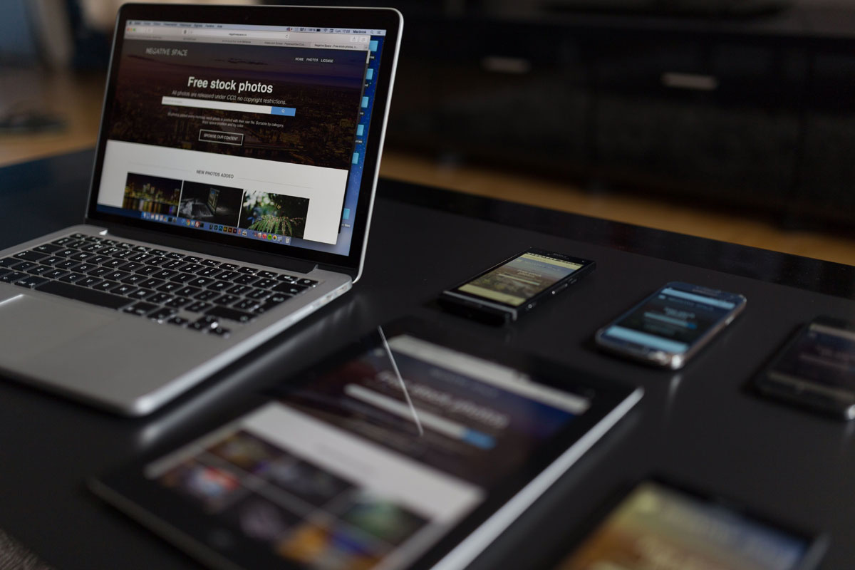 A contemporary workspace showcasing a laptop, tablet, and smartphones, ideal for tech and freelance use