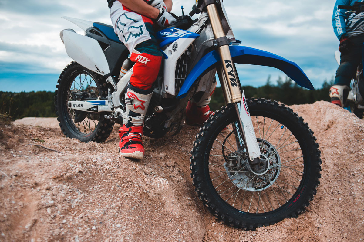 Dynamic image of a motorcyclist riding through a sandy off-road terrain, showcasing thrill and adventure