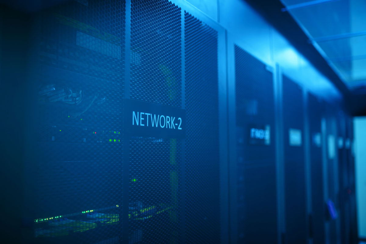 A modern server room featuring network equipment with blue illumination