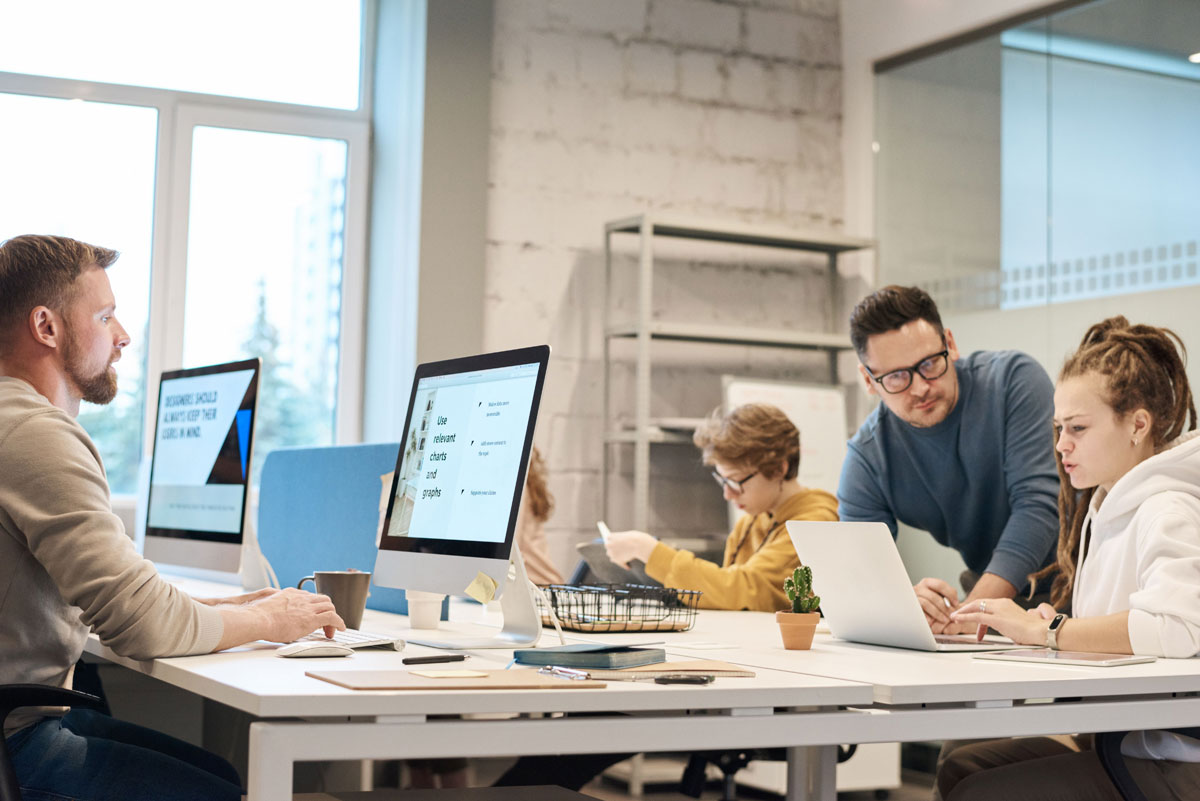 Team of professionals discussing project ideas in a modern office setting, fostering communication and teamwork.