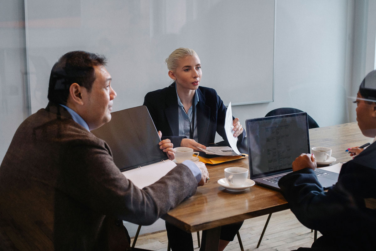 A diverse group of business professionals in a collaborative meeting discussing strategies.