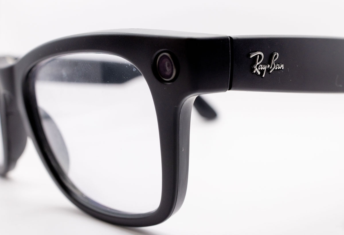 Detailed close-up shot of black smart glasses featuring a built-in camera, highlighting modern technology and design.