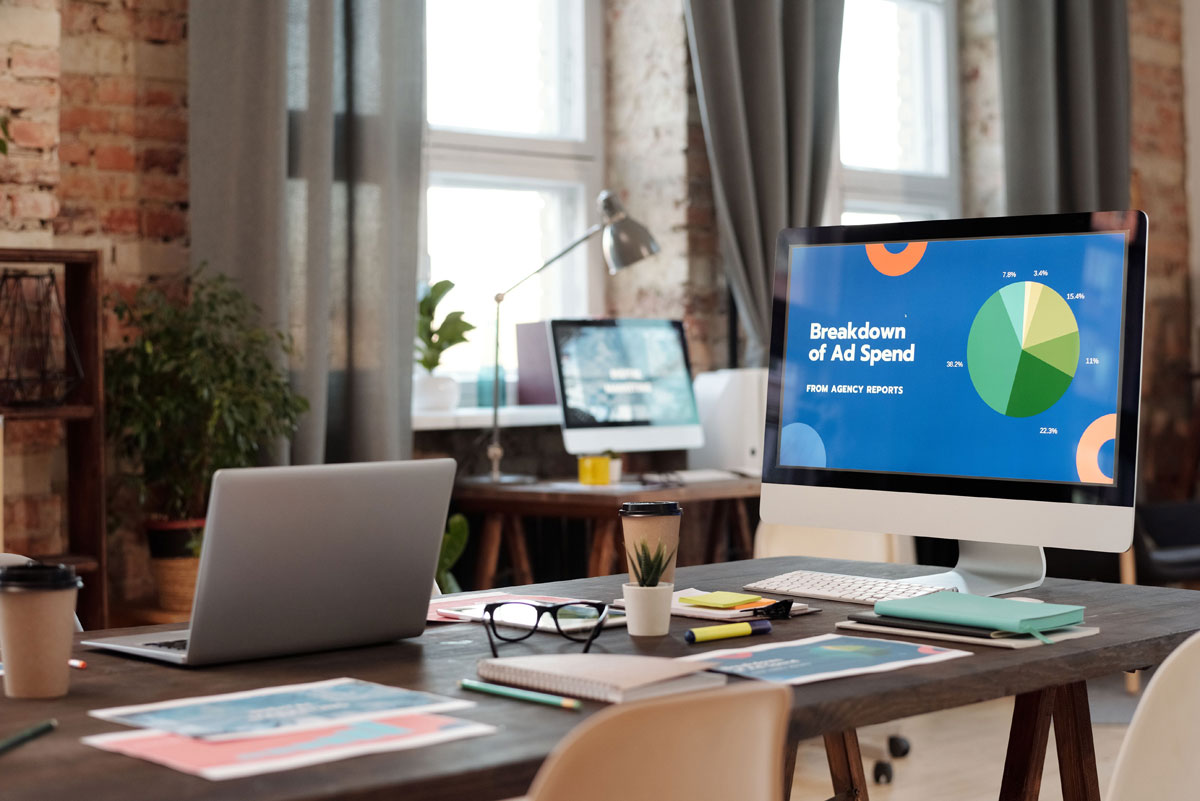 Breakdown of Ad Spend writing on laptop screen