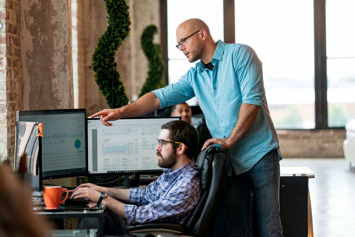 Team members collaborating on data analysis in a modern office