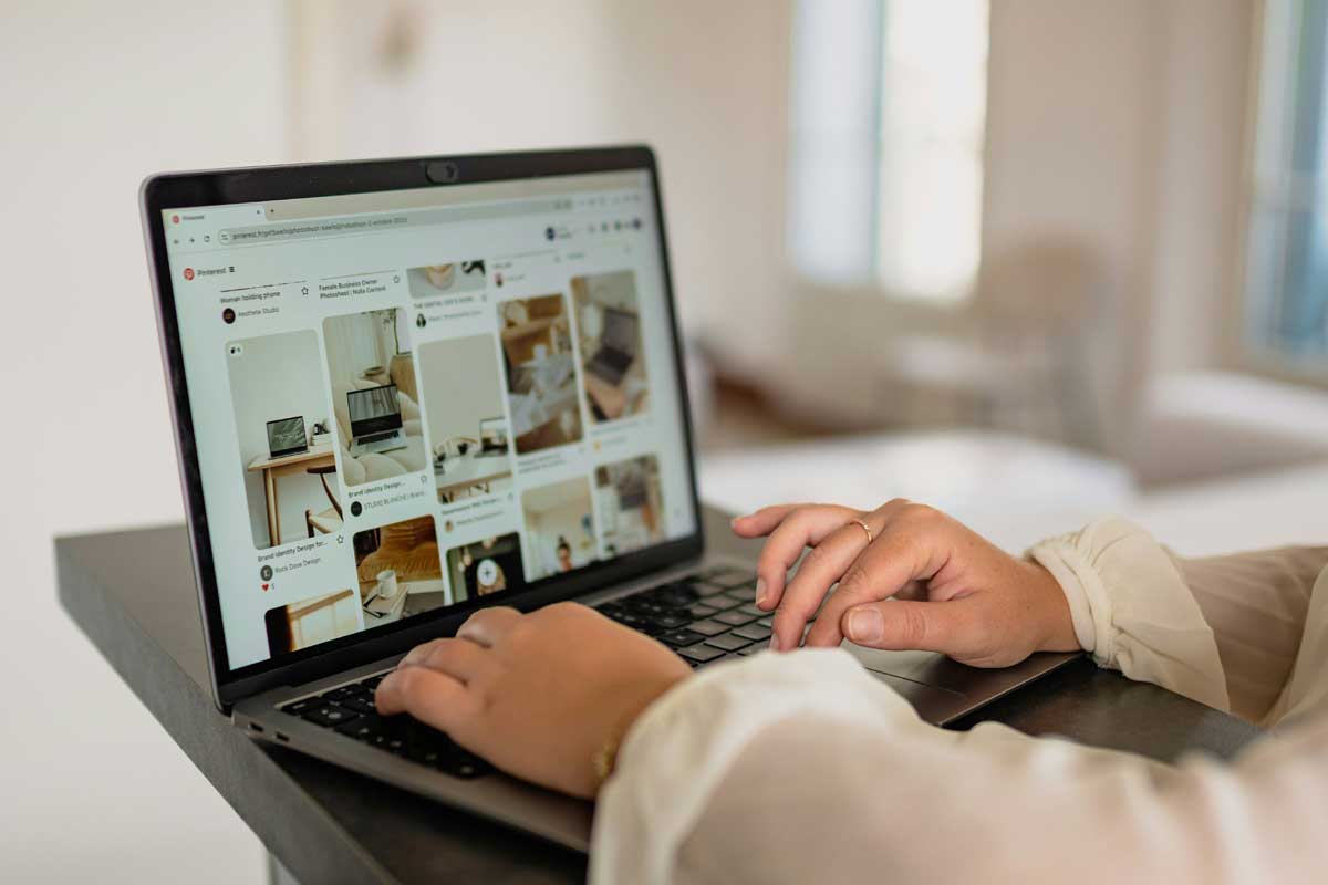 Person open Pinterest homepage using laptop